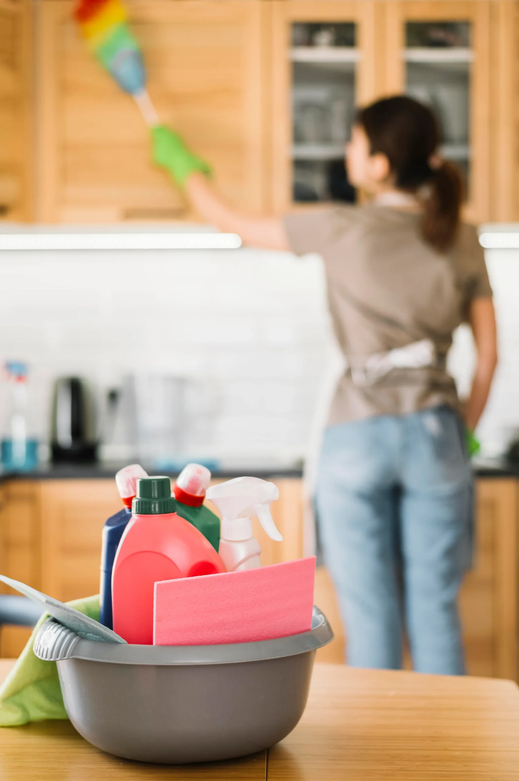 Blurred woman using fluffy duster